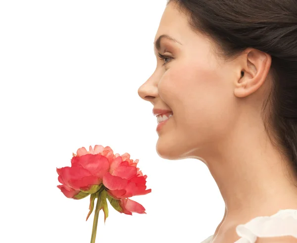 Smiling woman smelling flower — Stock Photo, Image