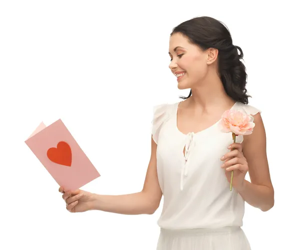 Young woman holding flower and postcard — Stock Photo, Image