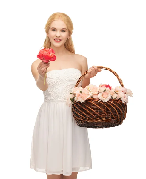 Woman with basket full of flowers — Stock Photo, Image