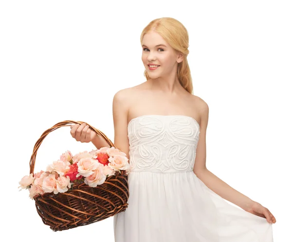 Woman with basket full of flowers — Stock Photo, Image