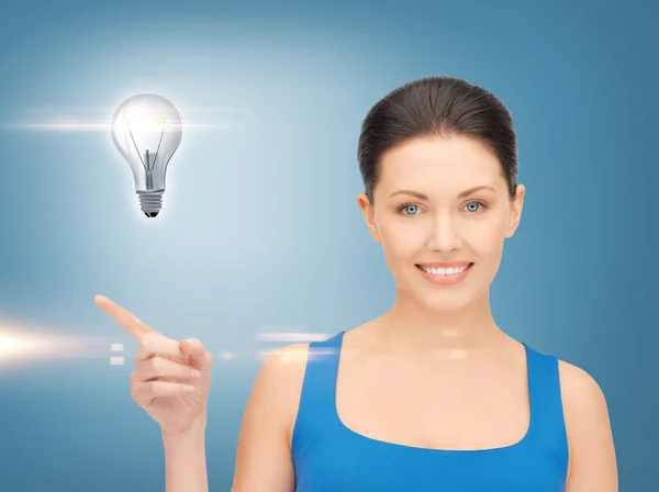 Woman showing light bulb on her hand — Stock Photo, Image