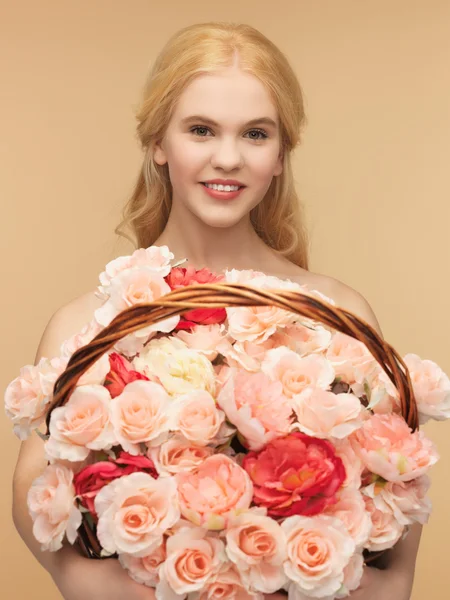 Woman with basket full of flowers — Stock Photo, Image