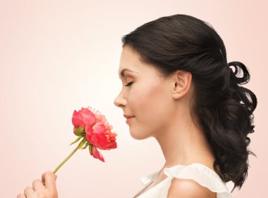 Smiling woman smelling flower clipart
