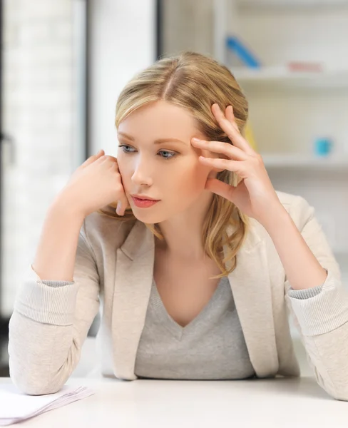 Bored and tired woman behind the table — Stock Photo, Image