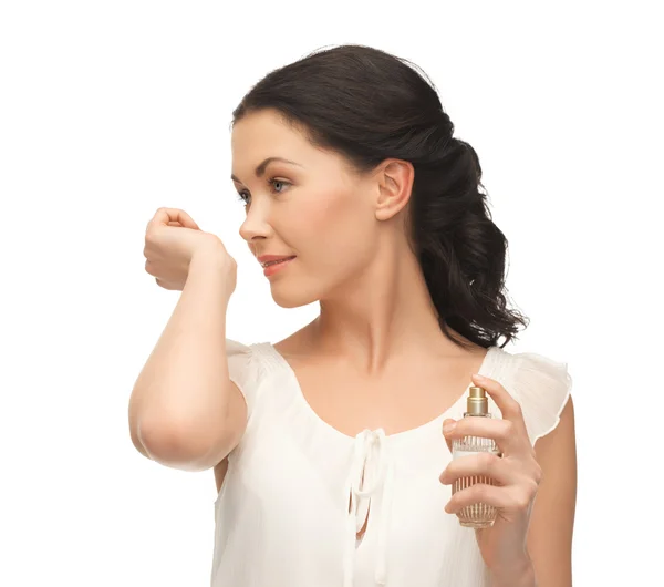 Woman smelling perfume on her hand — Stock Photo, Image