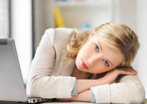 Bored and tired woman behind the table — Stock Photo, Image
