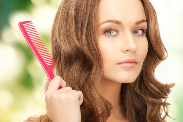 Beautiful woman with comb — Stock Photo, Image