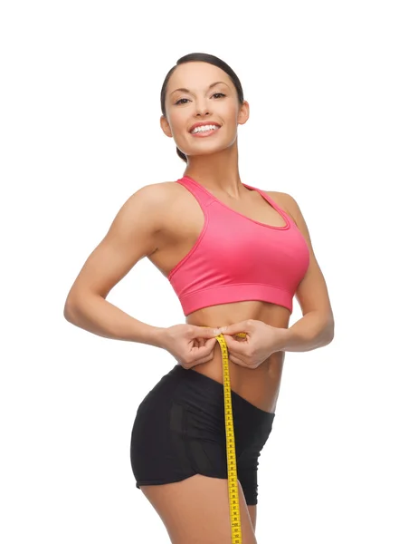 Sporty woman with measuring tape — Stock Photo, Image