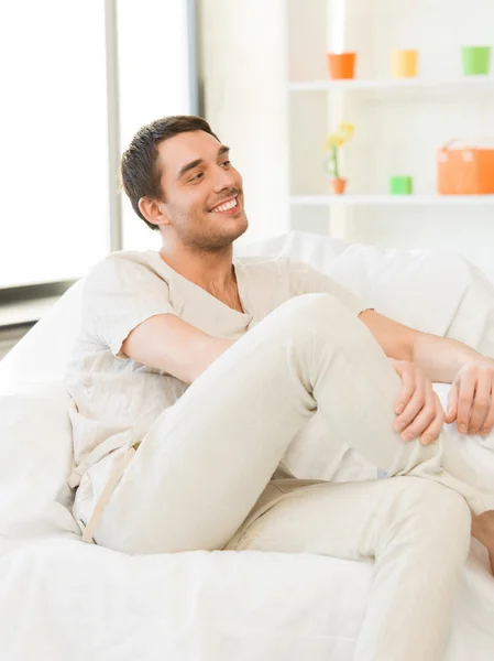 Handsome man sitting on the couch — Stock Photo, Image
