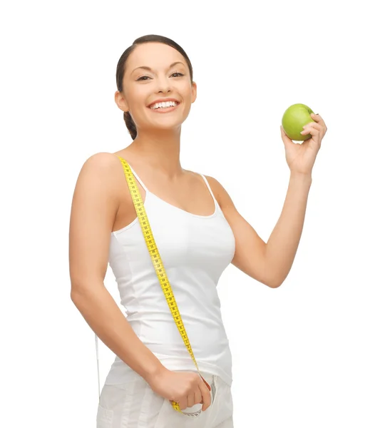 Sportos nő, az apple és a mérőszalag Stock Kép