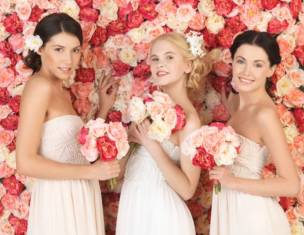 Three women with background full of roses Stock Picture