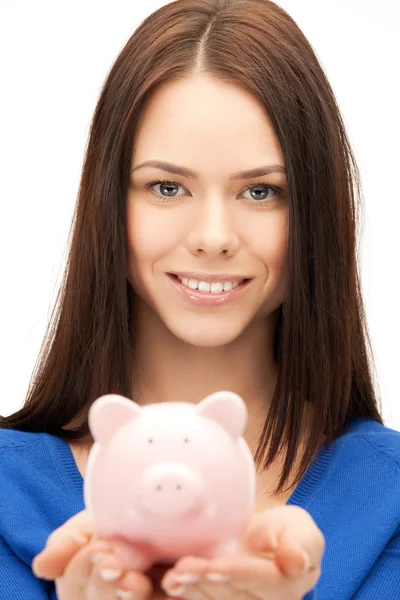Mulher encantadora com pequeno banco porquinho — Fotografia de Stock