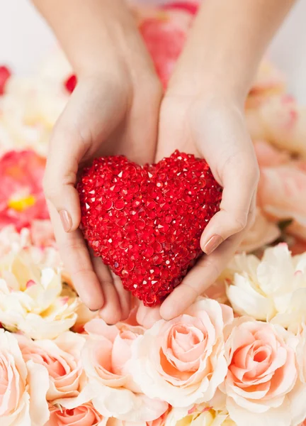 Woman's hands holding heart — Stock Photo, Image