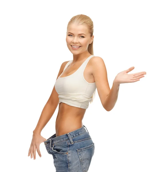 Sporty woman showing big pants — Stock Photo, Image