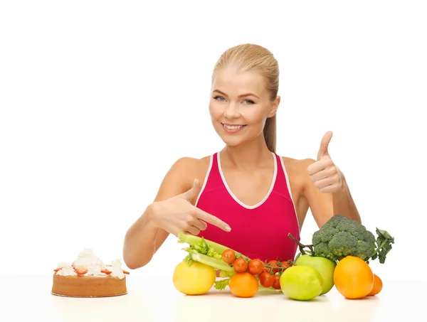 Žena ukazuje na zdravé jídlo — Stock fotografie