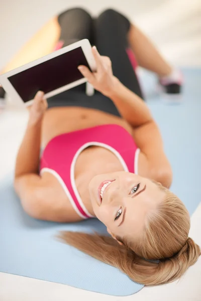 Woman lying on the floor with tablet pc — Stock Photo, Image