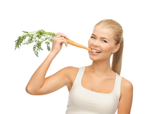 Healthy young woman biting carrot — Stock Photo, Image