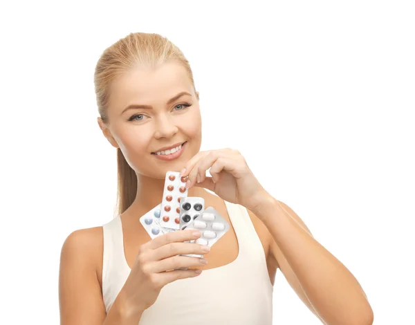 Young woman with pills — Stock Photo, Image