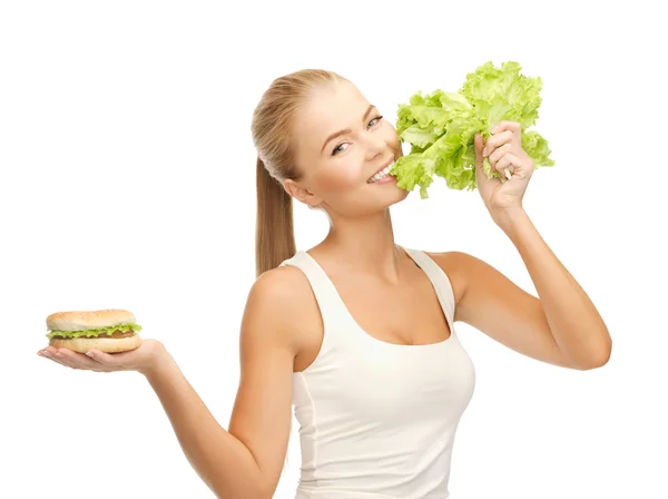 Žena s zeleným salátem a hamburger — Stock fotografie