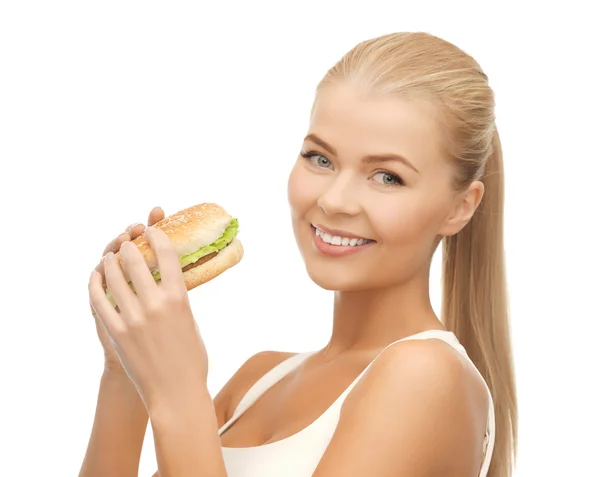 Woman eating junk food Rechtenvrije Stockafbeeldingen