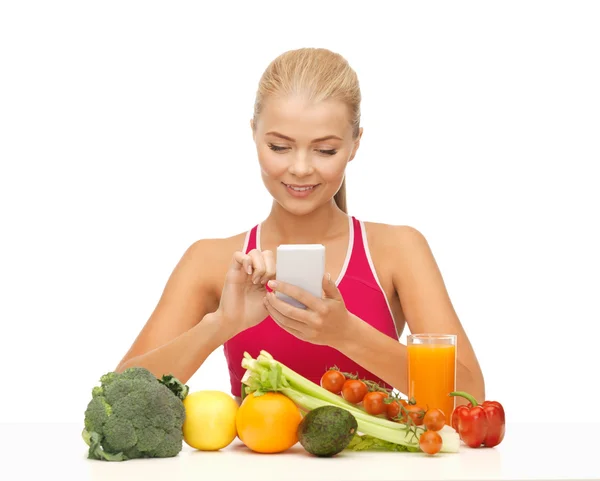 Mujer con frutas, verduras y smartphone — Stockfoto