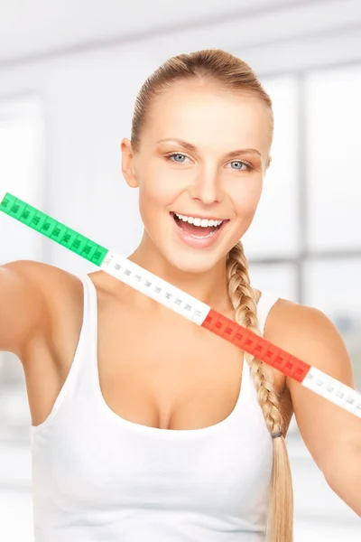 Young beautiful woman with measure tape — Stock Photo, Image