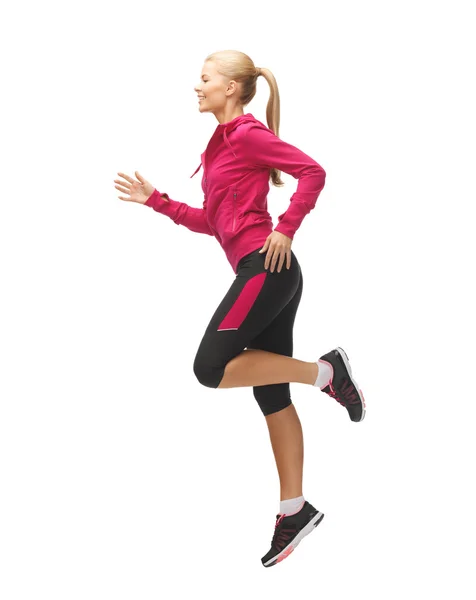 Sporty woman running or jumping — Stock Photo, Image