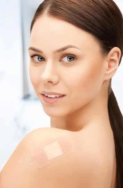 Beautiful woman with medical patch or plaster — Stock Photo, Image