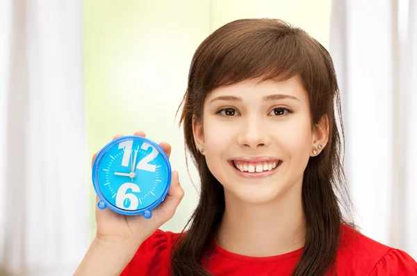Teenage girl holding alarm clock — Stock Photo, Image