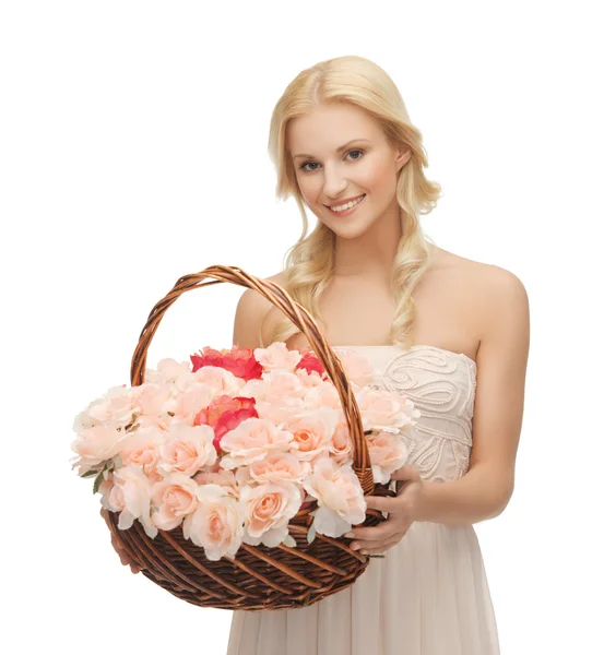 Woman with basket full of flowers — Stock Photo, Image