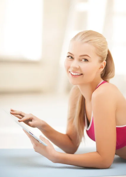 Woman lying on the floor with tablet pc — Stock Photo, Image