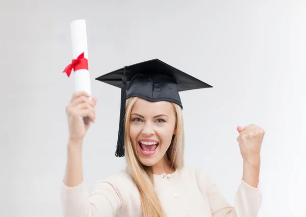 Student in graduation cap with certificate — Stock Photo, Image