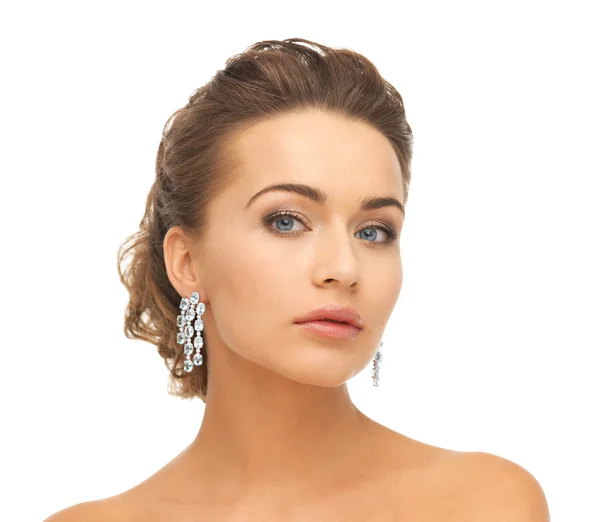 Woman wearing shiny diamond earrings — Stock Photo, Image