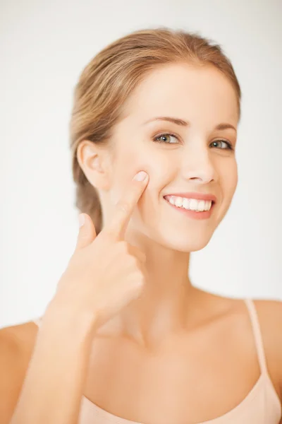 Woman pointing at her cheek — Stock Photo, Image