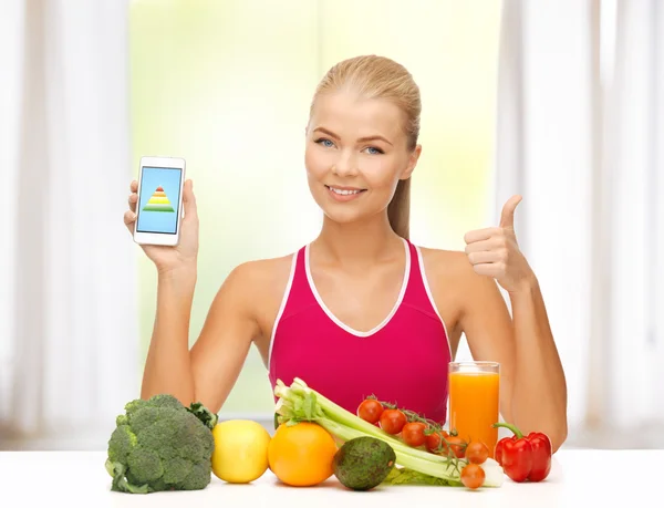 Kvinna med frukt, grönsaker och smartphone — Stockfoto