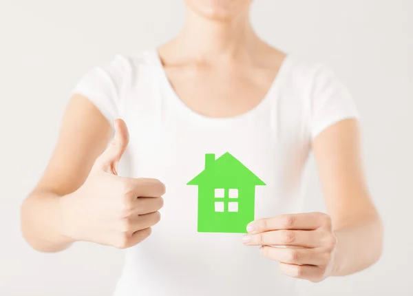 Woman hands holding green house — Stock Photo, Image