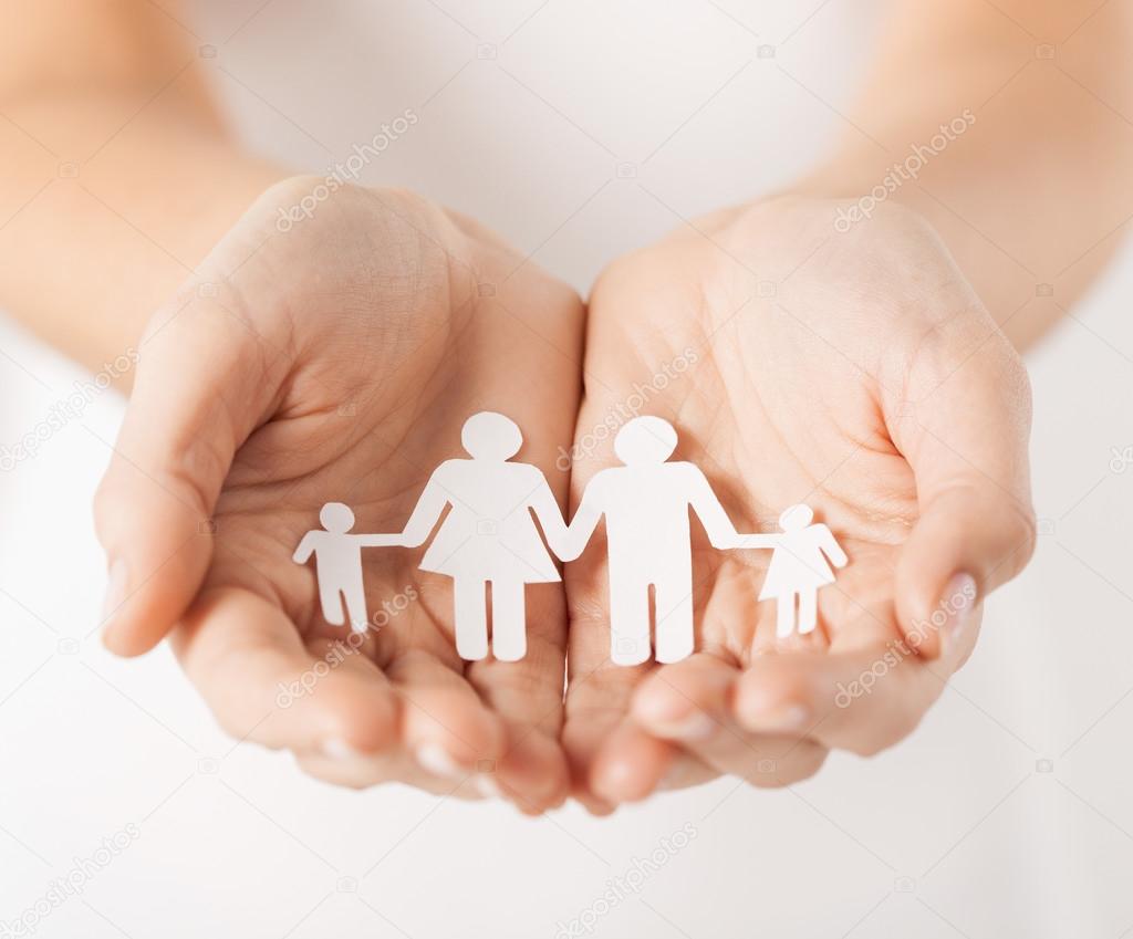 Close up of female cupped hands showing paper chain family