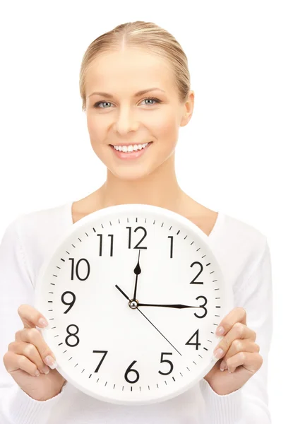 Businesswoman with wall clock Stock Image