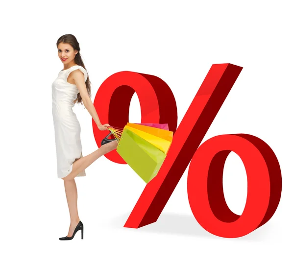 Woman with shopping bags and percent signs — Stock Photo, Image