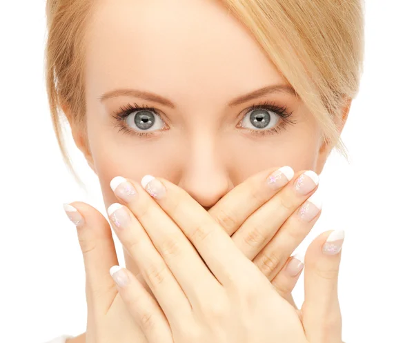 Amazed woman with hand over mouth Stock Image