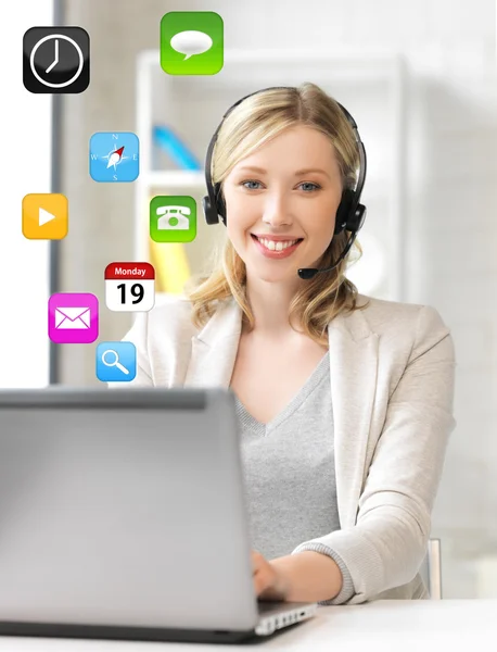 Friendly female helpline operator with laptop — Stock Photo, Image