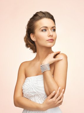 Woman with pearl earrings and bracelet clipart