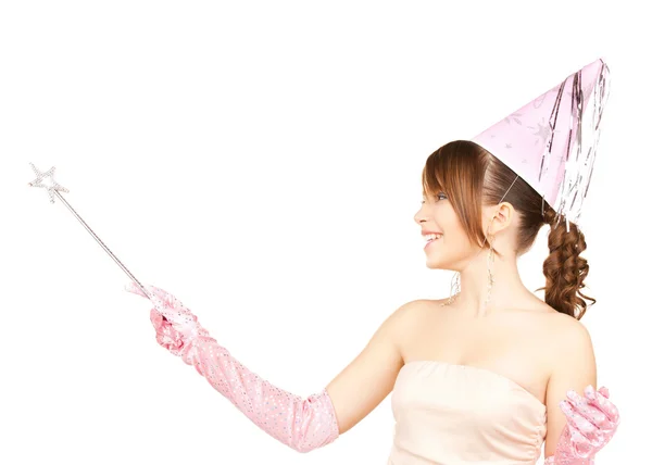 Girl in party cap with magic stick — Stock Photo, Image