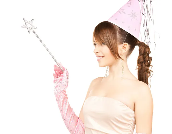 Girl in party cap with magic stick — Stock Photo, Image