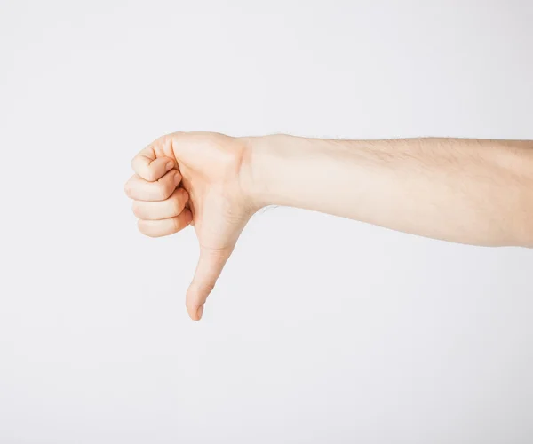 Man showing thumbs down — Stock Photo, Image
