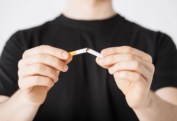 Man breaking the cigarette with hands — Stock Photo, Image