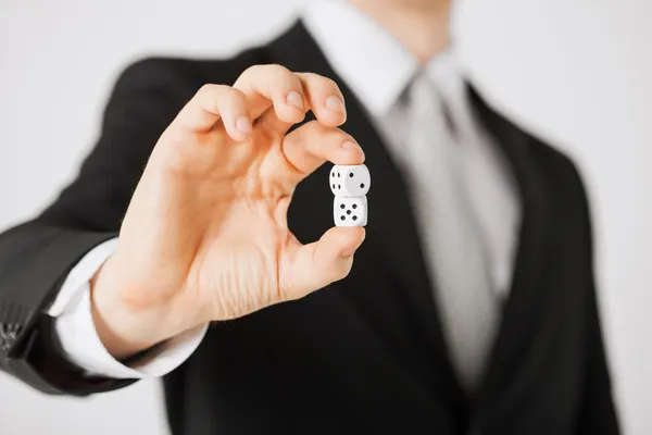 Mans hand holding white casino dice — Stock Photo, Image