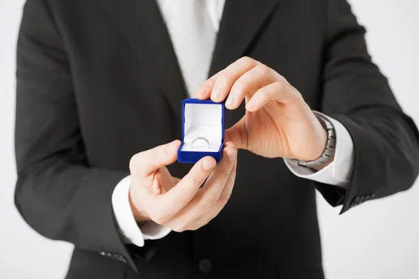 Man with gift box and wedding ring — Stock Photo, Image