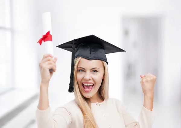Student in graduation cap with certificate — Stock Photo, Image