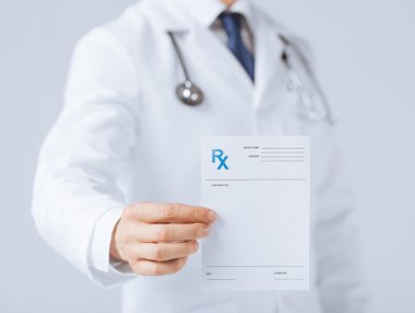Male doctor holding rx paper in hand clipart